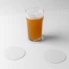Front view, standing on a white beer pad, transparent beer glass mockup, two white circle beer pad mockups lying on the white floor.