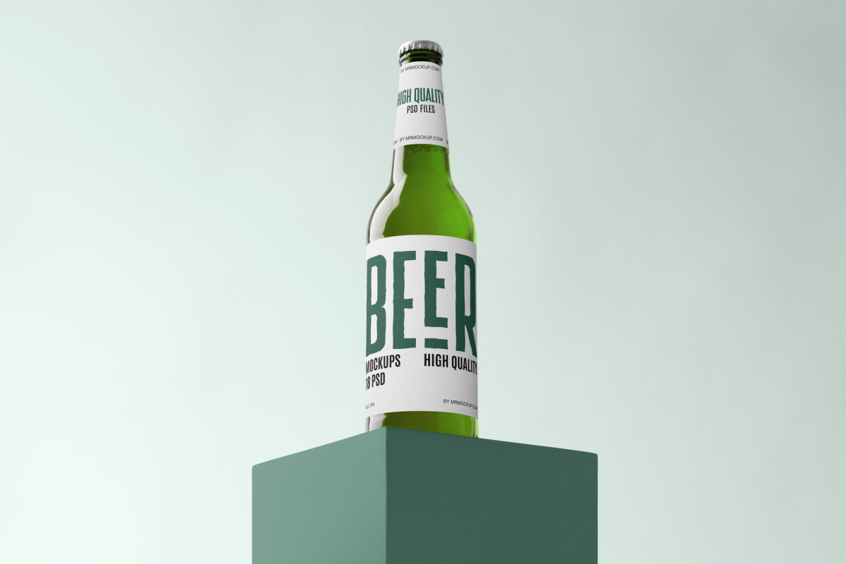 Front view, beer bottle mockups with white label and black and dark green design standing on the green box.