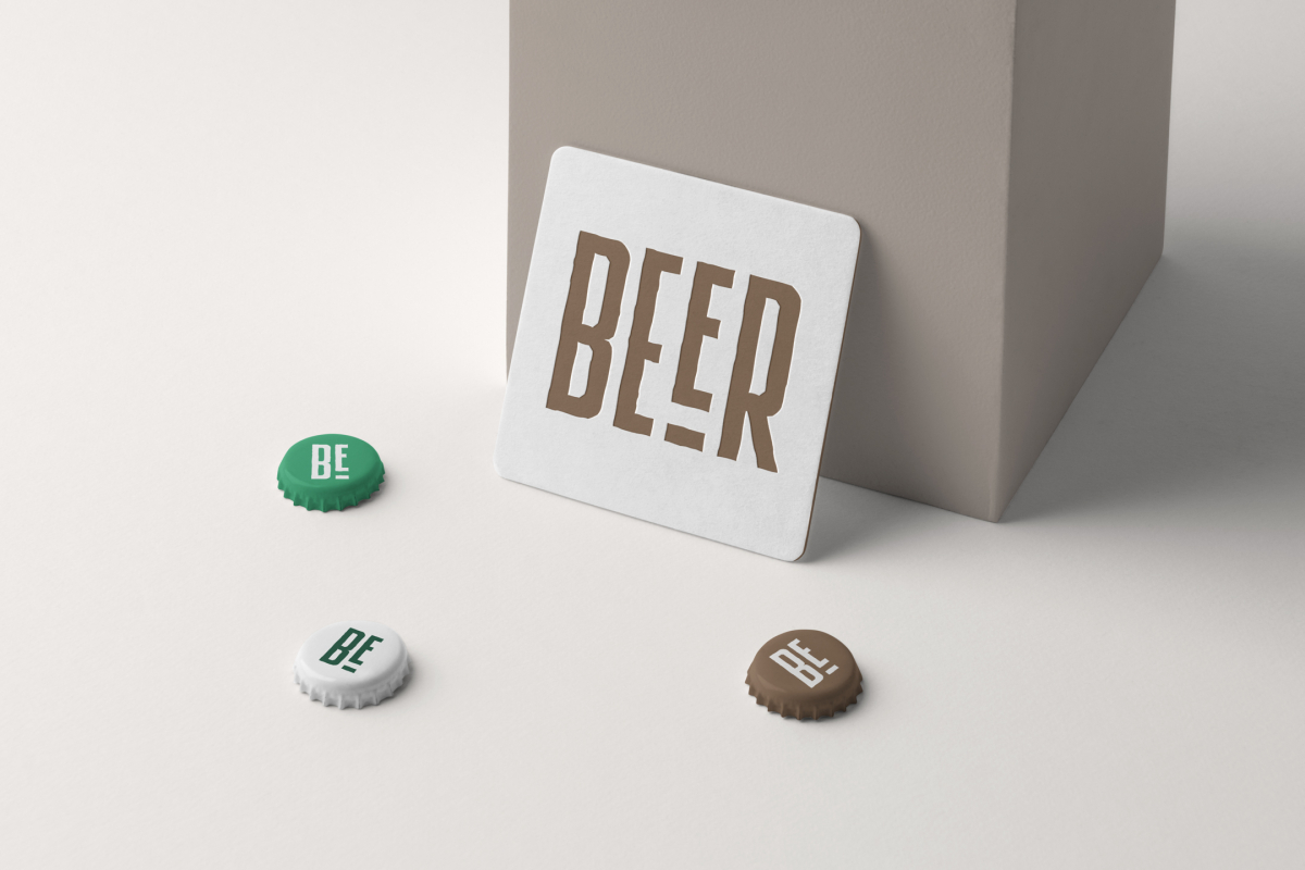 Front view, a white beer pad mockup leans on a beige box, and three beer crown cups lying on the white background.