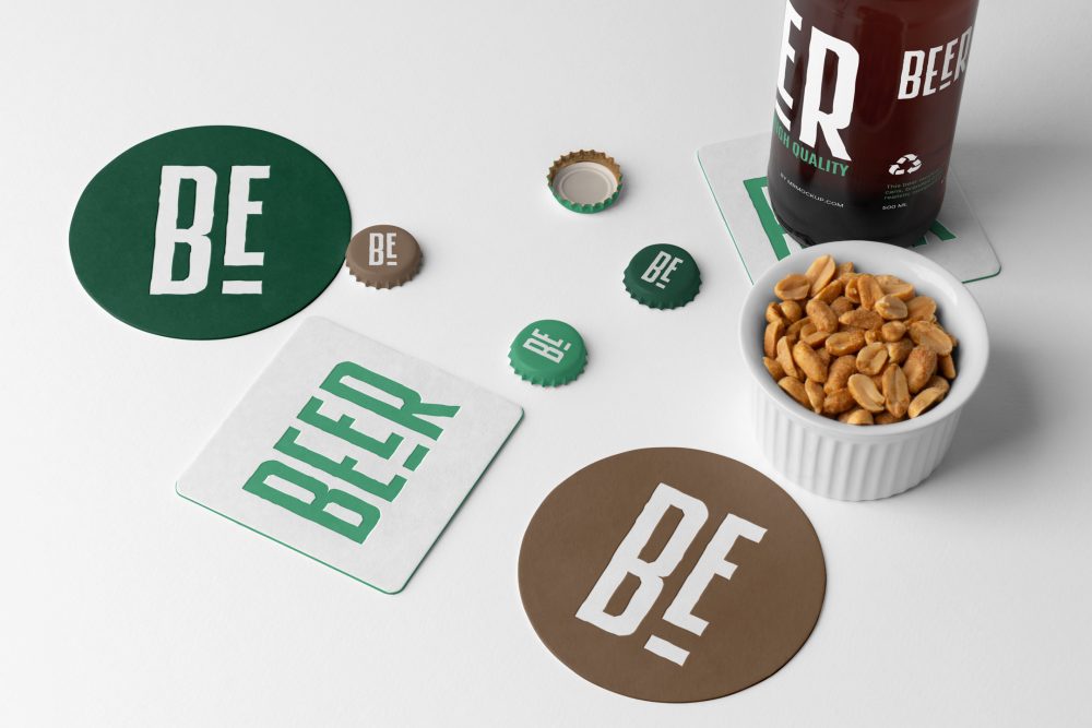 View from above, four beer pad and crown cup mockups with big white or green typography logo designs, a beer bottle mockup, and a white peanut container lying on the white background.