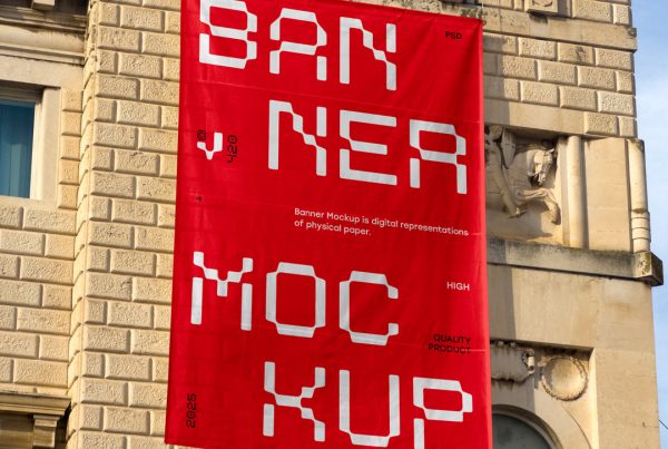 Front view, vertical red banner mockup with strong white and black typography design hanging on the building facade.