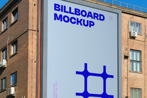 Front view, vertical blue billboard mocku with strong pink and navy typography design attached on the building facade.