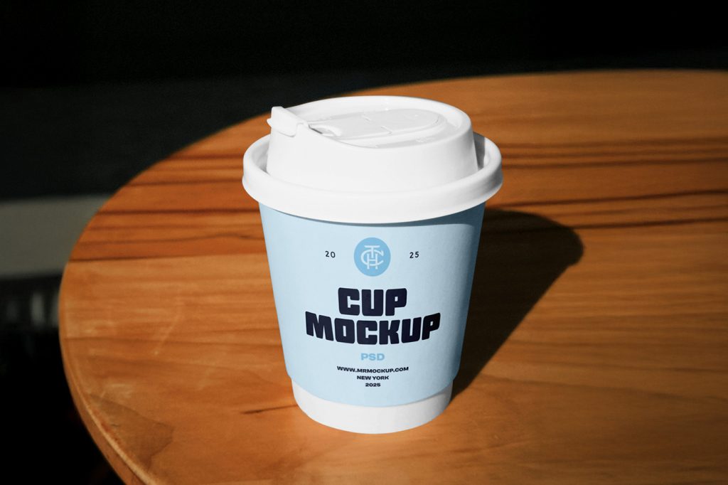 Front view baby blue coffee cup mockup with a typography design standing on the wooden table.