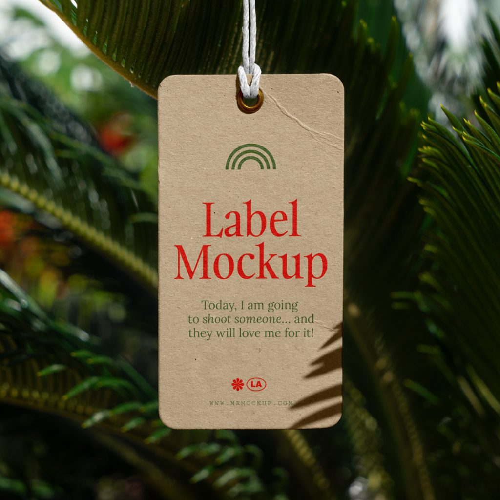 Front view, craft label mockup with red and green typography design hanging on the tropical plants.