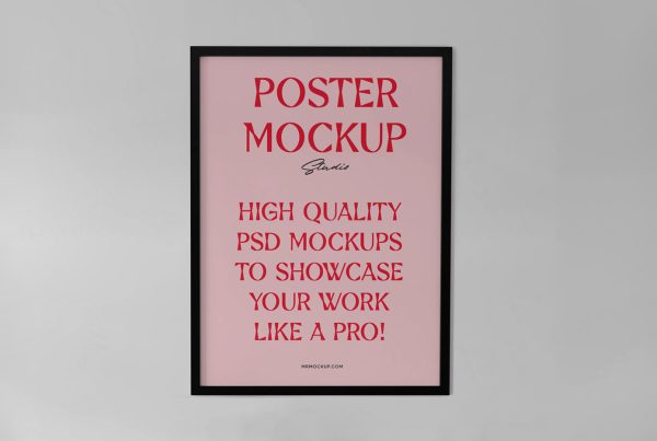 Front view, pink poster mockup with a black frame and red and black typography design hanging on the white wall.