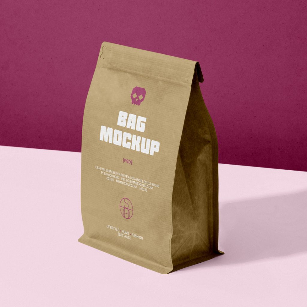 Front view, craft paper coffee bag mockup standing on the pink table against the burgundy wall.