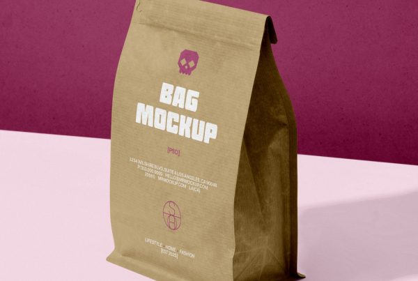 Front view, craft paper coffee bag mockup standing on the pink table against the burgundy wall.