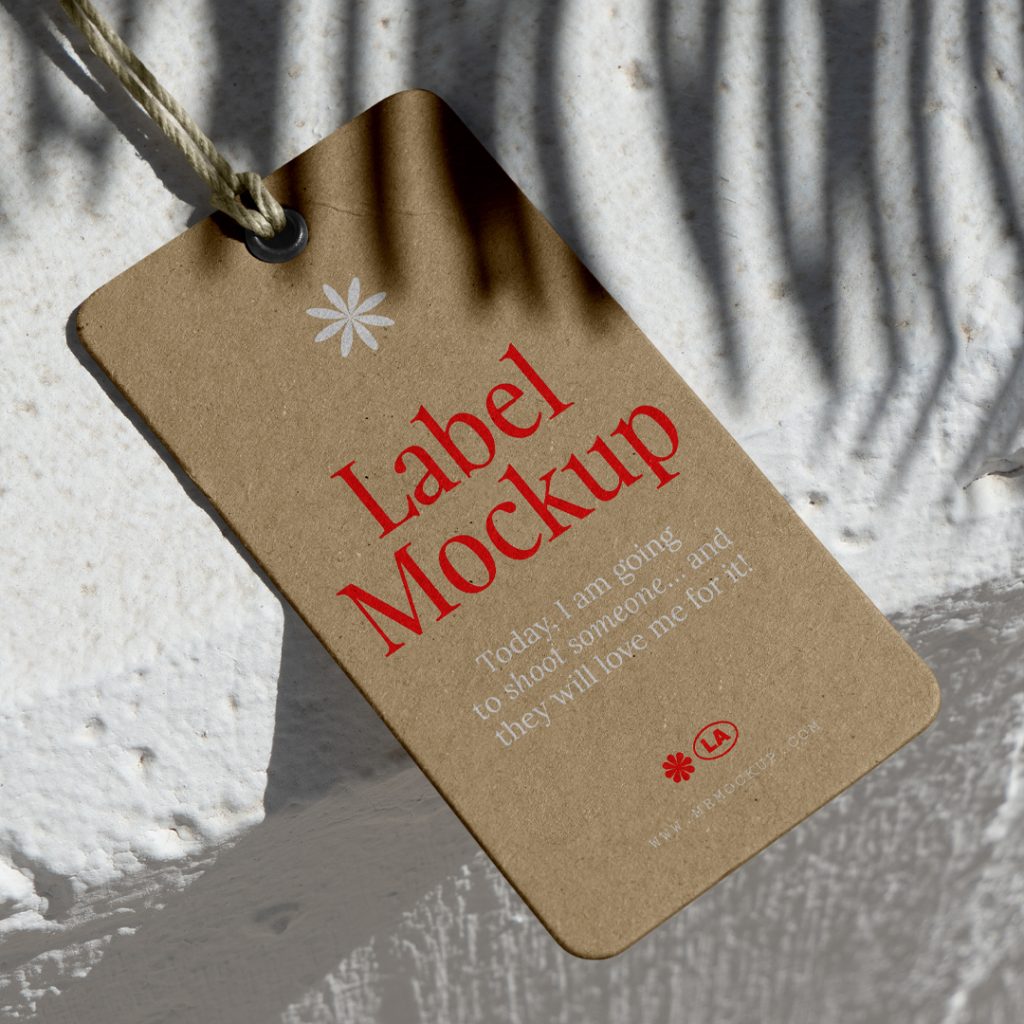 View from above, craft label mockup with red and white typography design lying on the concrete white wall.