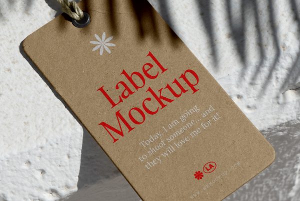 View from above, craft label mockup with red and white typography design lying on the concrete white wall.