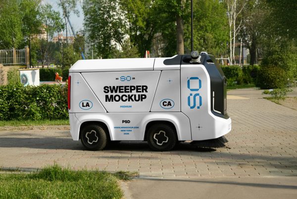 Front view, a white mini sweeper mockup with strong typography design in black and blue colors working on the sidewalk.