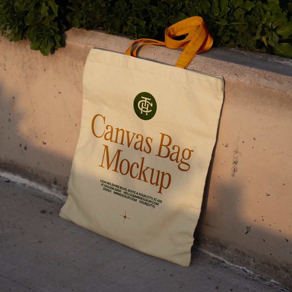 Front view, canvas bag mockup in crème color with an orange handle and green and orange typography design based on the concrete wall.
