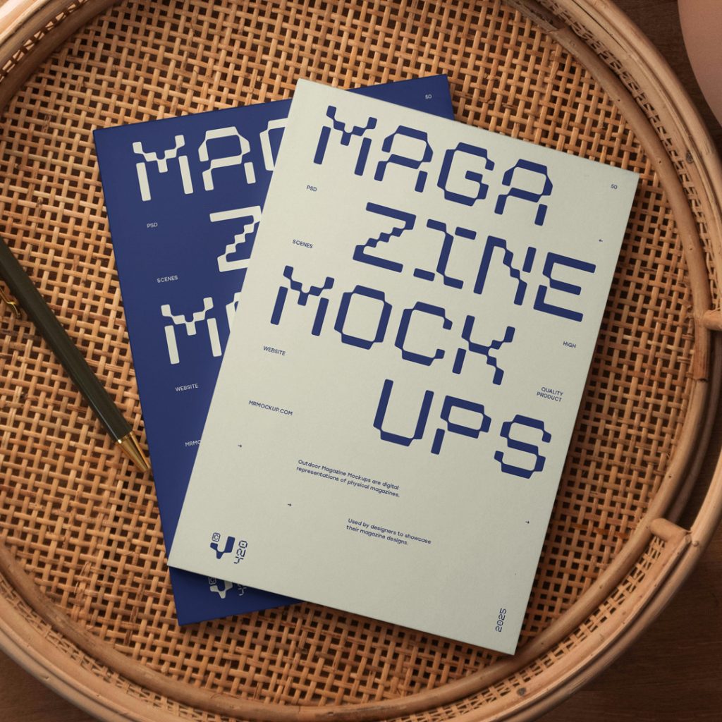 View from above of two magazine mockups with strong navy typography designs lying on a wicker table.
