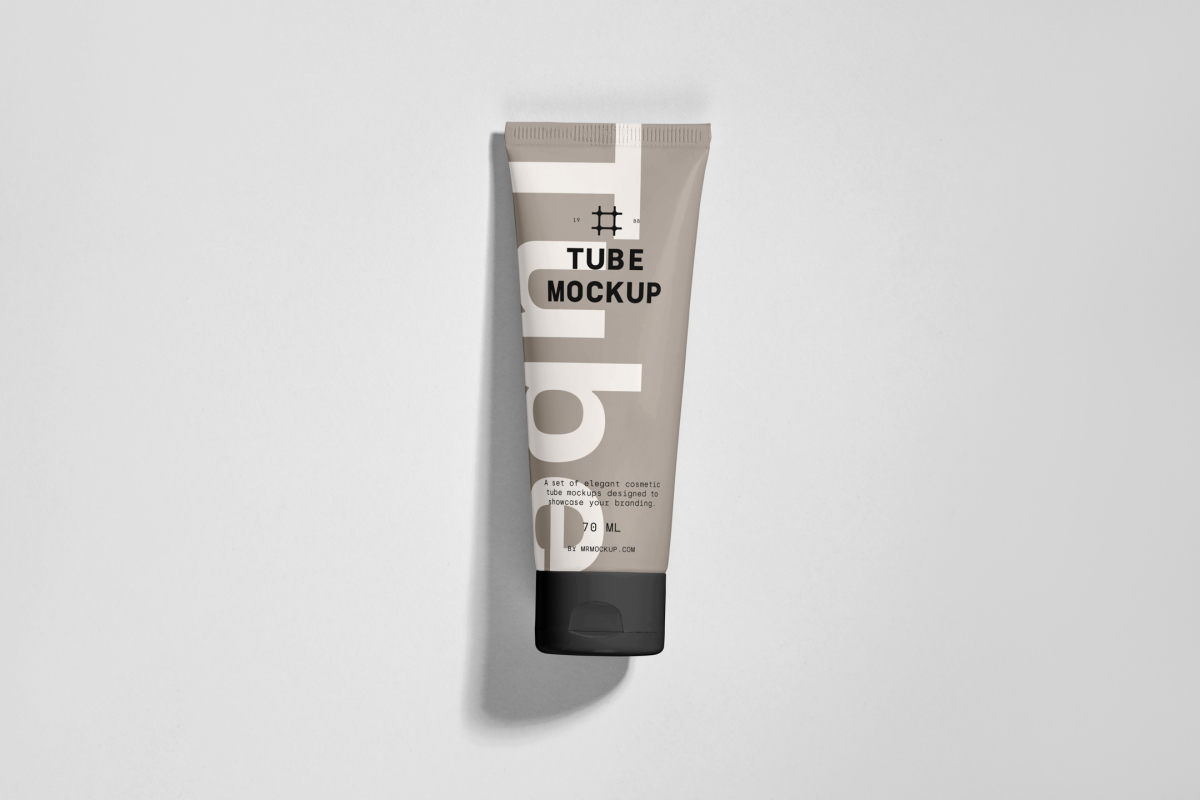View from above, a Cosmetic Tube Mockups with delicate cosmetic design in black, cream, and beige colors, lying on a white colored background.