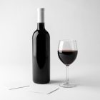Front view, the scene from Studio Wine Mockups of a standing black wine bottle, transparent wine glass, and two paper pads on the white background.