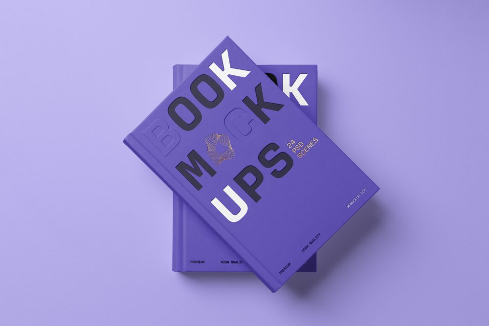View from above, two hardcover book mockups with bold typography design in black, gold, purple, and white colors in PSD lying on top of each other for cover design and branding presentation on a purple background.