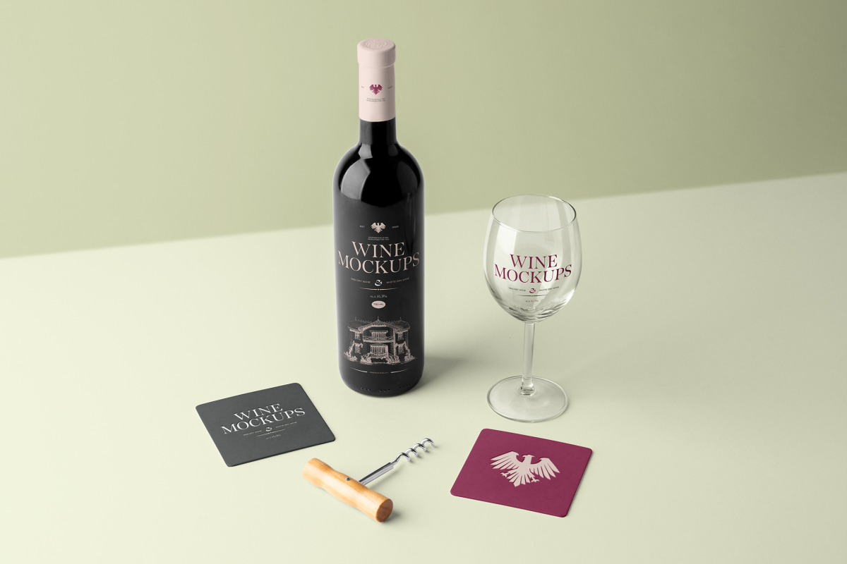 View from above, scene from Studio Wine Mockups of a standing black wine bottle with pink typography design, transparent wine glass with claret typography design, and two paper pads on the bright green background.