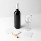 View from above, scene from Studio Wine Mockups of a standing black wine bottle, transparent wine glass, and two paper pads on the white background.