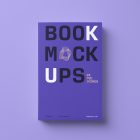 View from above, single softcover book mockup with bold typography design in black, gold, purple, and white colors for minimalist book cover and publishing design, lying on a purple background.
