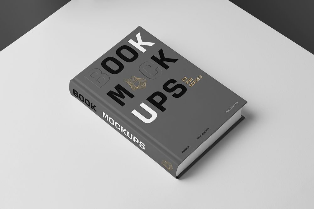 Top view at an angle of a hardcover book mockup in PSD with bold typography design in black, gold, gray, and white colors showing the cover and spine in perspective view on the white background.