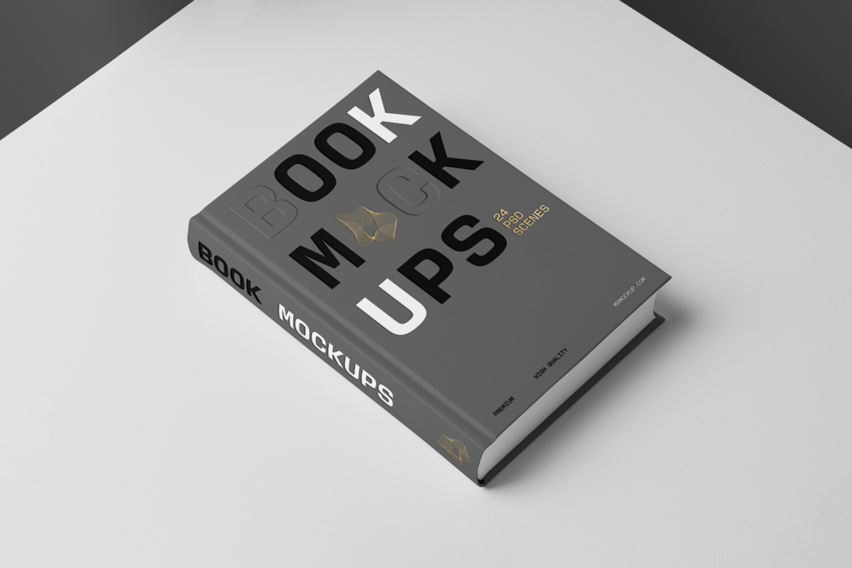 Top view at an angle of a hardcover book mockup in PSD with bold typography design in black, gold, gray, and white colors showing the cover and spine in perspective view on the white background.