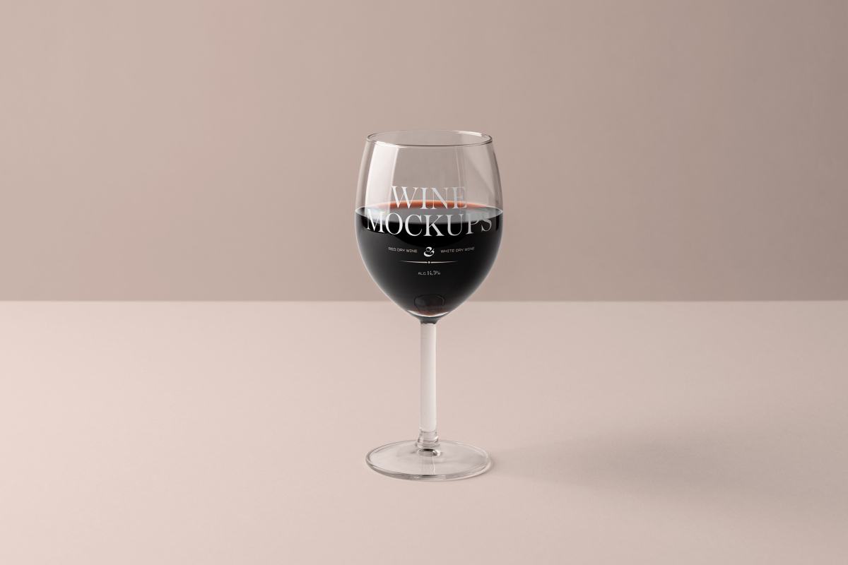 Front view, scene from Studio Wine Mockups of a transparent wine glass with typography design standing on the pink background.