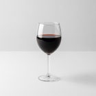 Front view, scene from Studio Wine Mockups of a transparent wine glass standing on the white background.