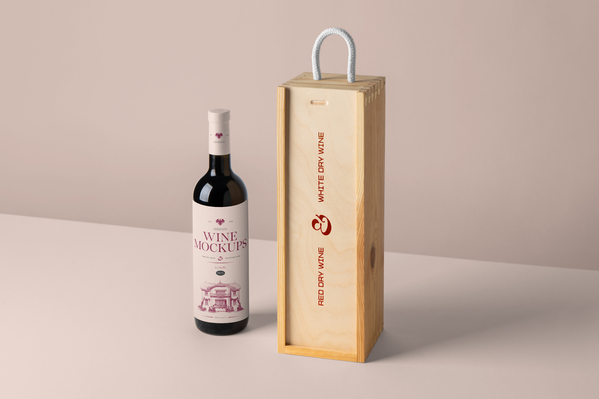 Front view, scene from Studio Wine Mockups of a standing black wine bottle with a pink label and typography design near a wooden wine box with typography design showing a burn effect on the pink background.