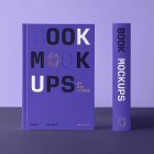 Front view, two hardcover book mockups with bold typography design in black, gold, purple, and white colors perfect for cover design and branding presentation standing on the dark purple background.