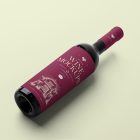 View from above the scene from Studio Wine Mockups of a black wine bottle with a claret label and typography design lying on the bright green background.