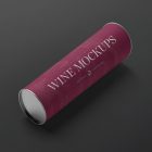 View from above the scene from Studio Wine Mockups of a wine tube package in claret color and typography design lying on the black background.
