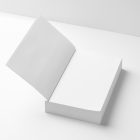 View from above, a white open hardcover book mockup lying on the white background in perspective view.