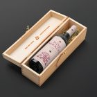 View from above, the scene from Studio Wine Mockups of an open wooden box with a black bottle of wine inside with a pink label and typography design lying on the black background.