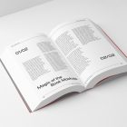 View from above, an open softcover book mockup with typography text design in black color lying on the white background in perspective view.