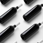 View from above the scene from Studio Wine Mockups of twelve black wine bottles lying on the white background.
