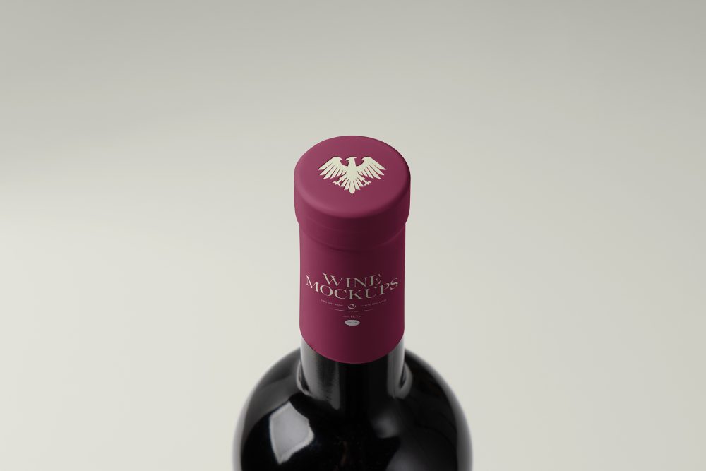 View from above, the scene from Studio Wine Mockups of a standing wine bottle with a claret plastic cap with typography design on the bright gray background.