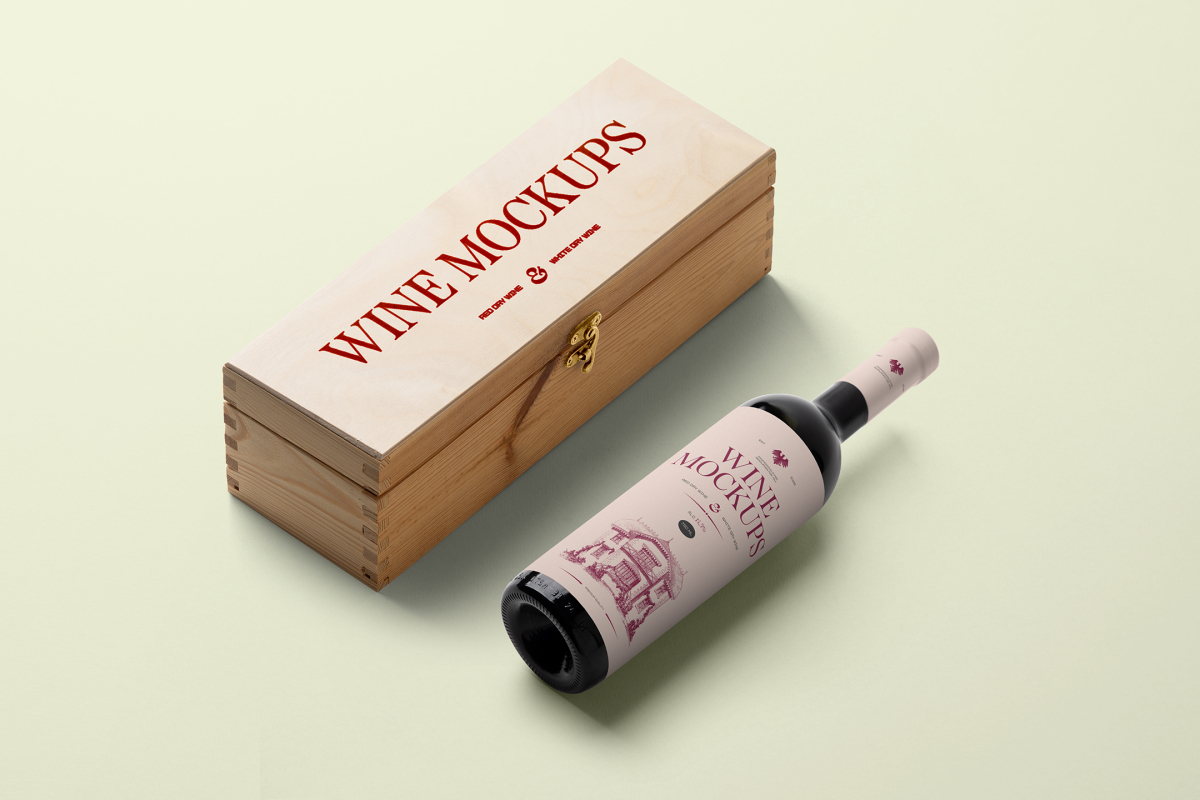 View from above, the scene from Studio Wine Mockups of a closed wooden wine box with a typography design showing a burn effect with a black bottle of wine with a pink label and typography design lying near on the bright green background.