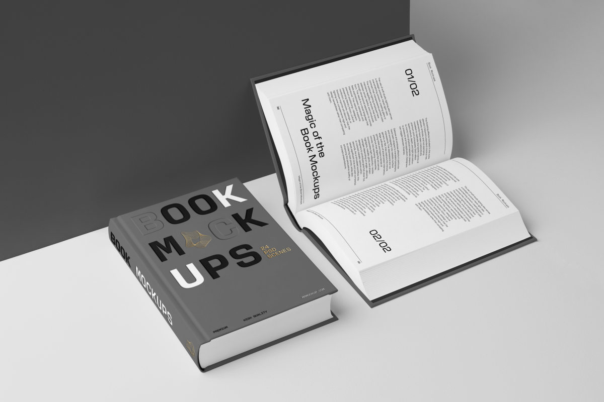 View from above, two hardcover book mockups with bold typography design in black, gold, gray, and white colors lying on the white background in perspective view.