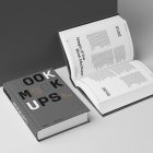 View from above, two hardcover book mockups with bold typography design in black, gold, gray, and white colors lying on the white background in perspective view.