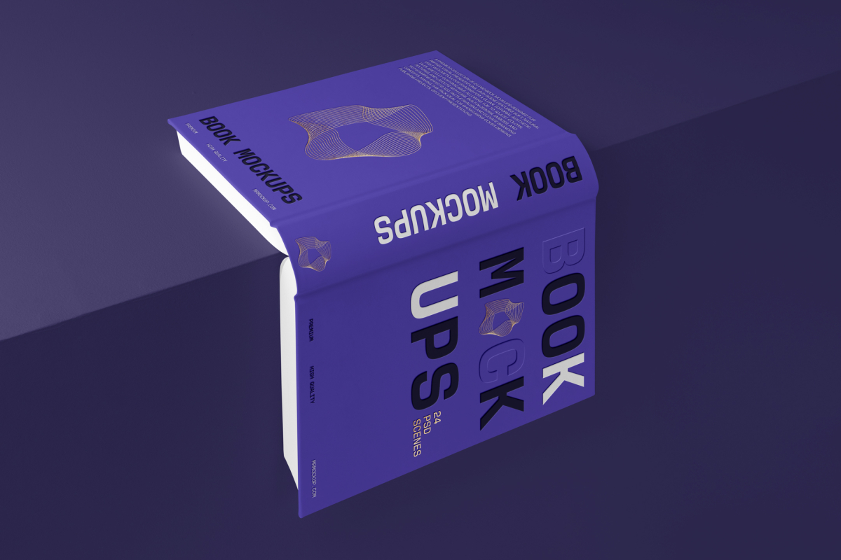 View from above, an open hardcover book mockup with bold typography design in black, gold, purple, and white colors lying on the edge of the purple cube.