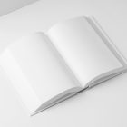 View from above, a white open hardcover book mockup lying on the white background in perspective view.