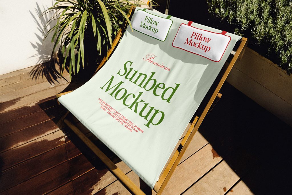 View from above, a wide wooden green sunbed mockup with green and red typography design and two pillow mockups stands on the balcony.