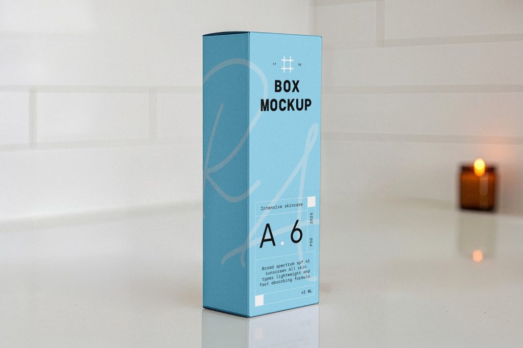 In the front view, a single blue vertical box mockup with delicate cosmetic design in white and black colors stands in the bathroom.