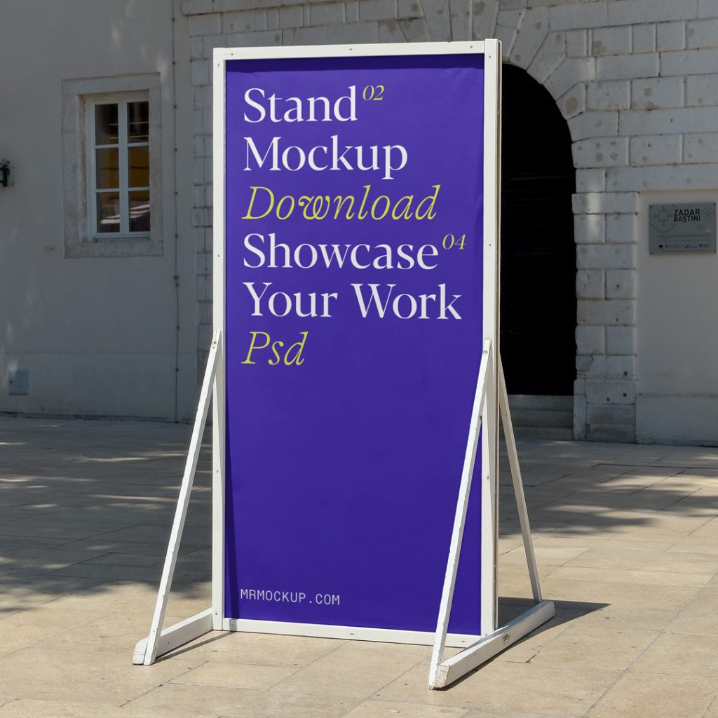 Front view, tall metal stand mockup with simple typography design in white and yellow colors standing against the old building.