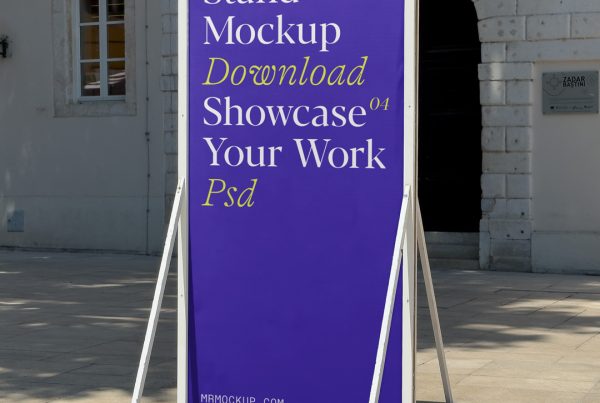 Front view, tall metal stand mockup with simple typography design in white and yellow colors standing against the old building.