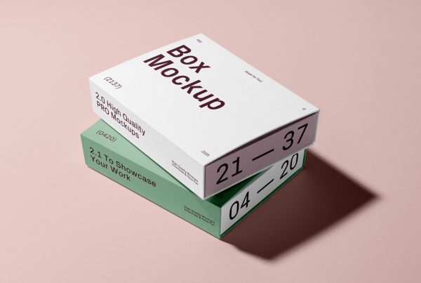View of two box mockups in white and green colors and strong black and brown typography design lying on top of each other on the pink background.