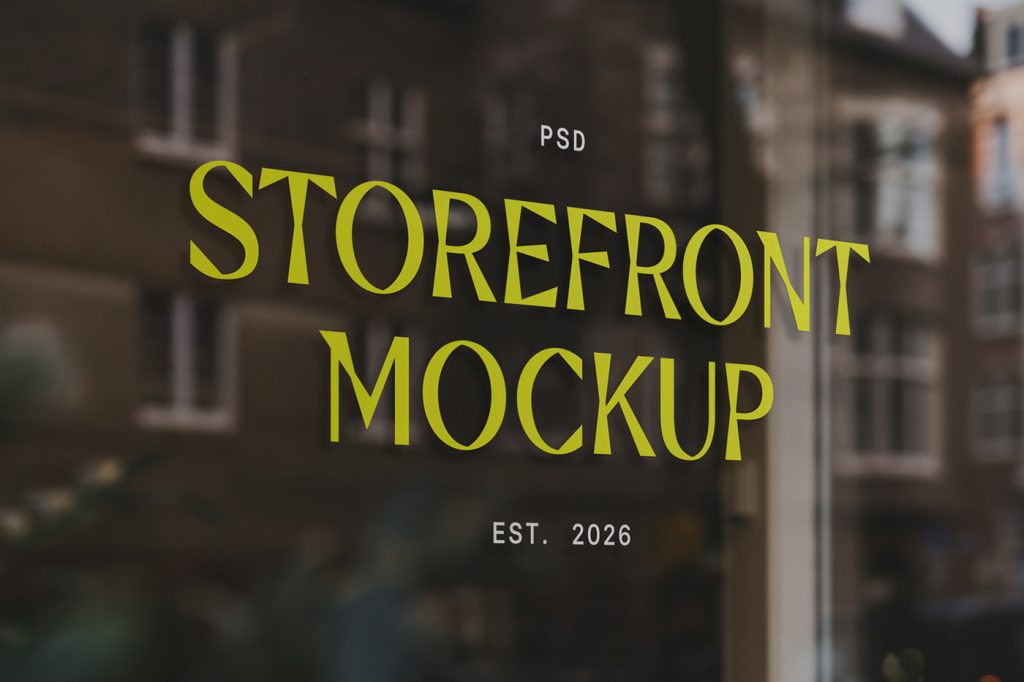 Front view, at an angle of 45 degrees, clean glass restaurant storefront mockup with yellow and white serif typography design.