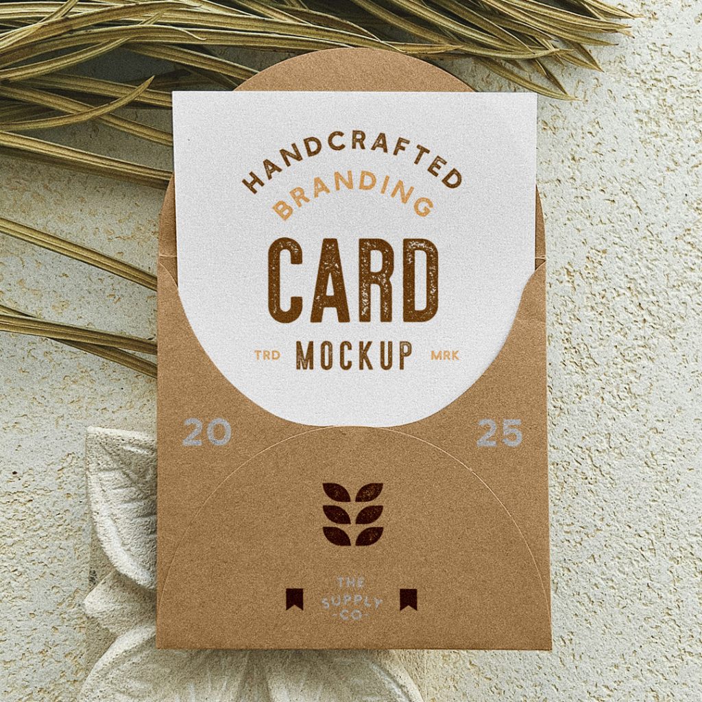 View from above, card inside the craft envelope mockup with a vintage typography design lying on the concrete floor.