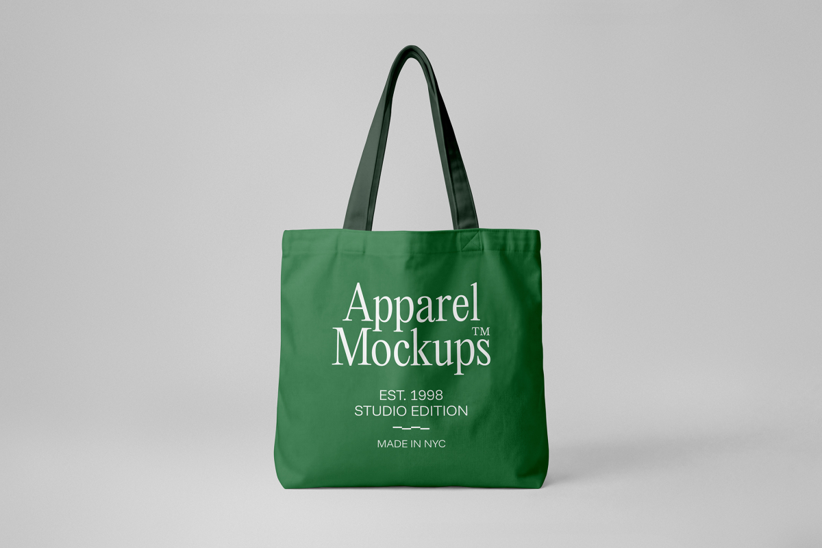 Front view, green canvas bag mockup with typography design in white color from studio apparel mockups product.