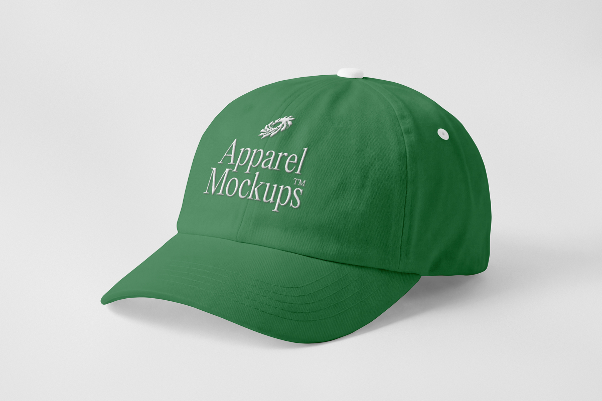 Front view, lying green baseball cap mockup with white typography design on the grey studio background from the studio apparel mockups product.