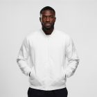 Front view, Black male model wearing a white jacket mockup standing against the white studio background from the studio apparel mockups product.